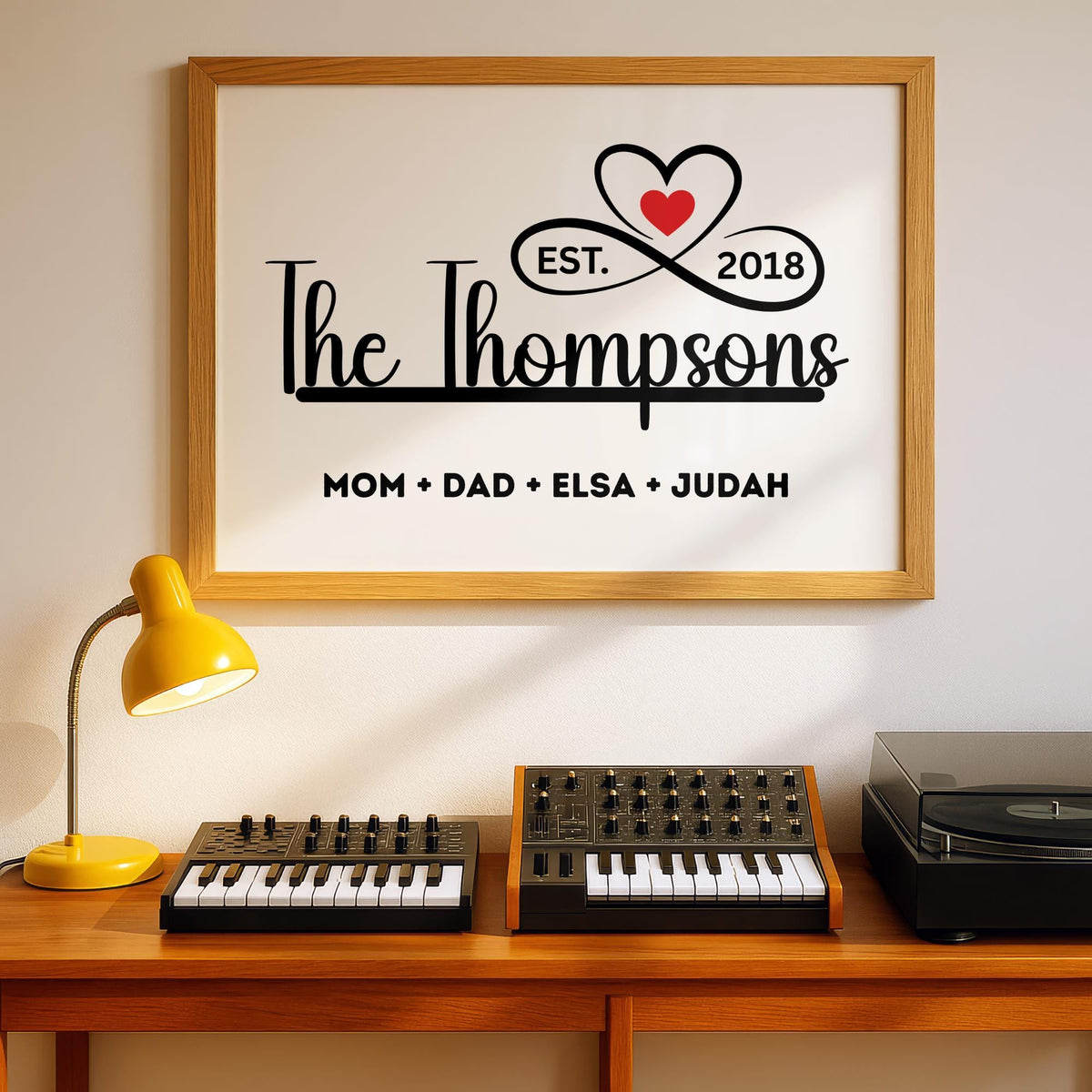 Personalized family name sign with custom family members print in a sleek black and white minimalist design. Framed canvas wall décor ideal for farmhouse, modern, or contemporary home settings. Thoughtful housewarming, wedding, or anniversary gift idea for families and couples. Perfect for display in living rooms, entryways, offices, or hallways as a meaningful keepsake. With infinity sign and a heart icon design