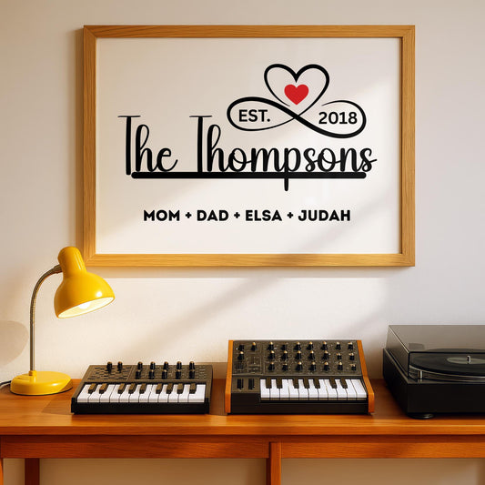 Personalized family name sign with custom family members print in a sleek black and white minimalist design. Framed canvas wall décor ideal for farmhouse, modern, or contemporary home settings. Thoughtful housewarming, wedding, or anniversary gift idea for families and couples. Perfect for display in living rooms, entryways, offices, or hallways as a meaningful keepsake. With infinity sign and a heart icon design