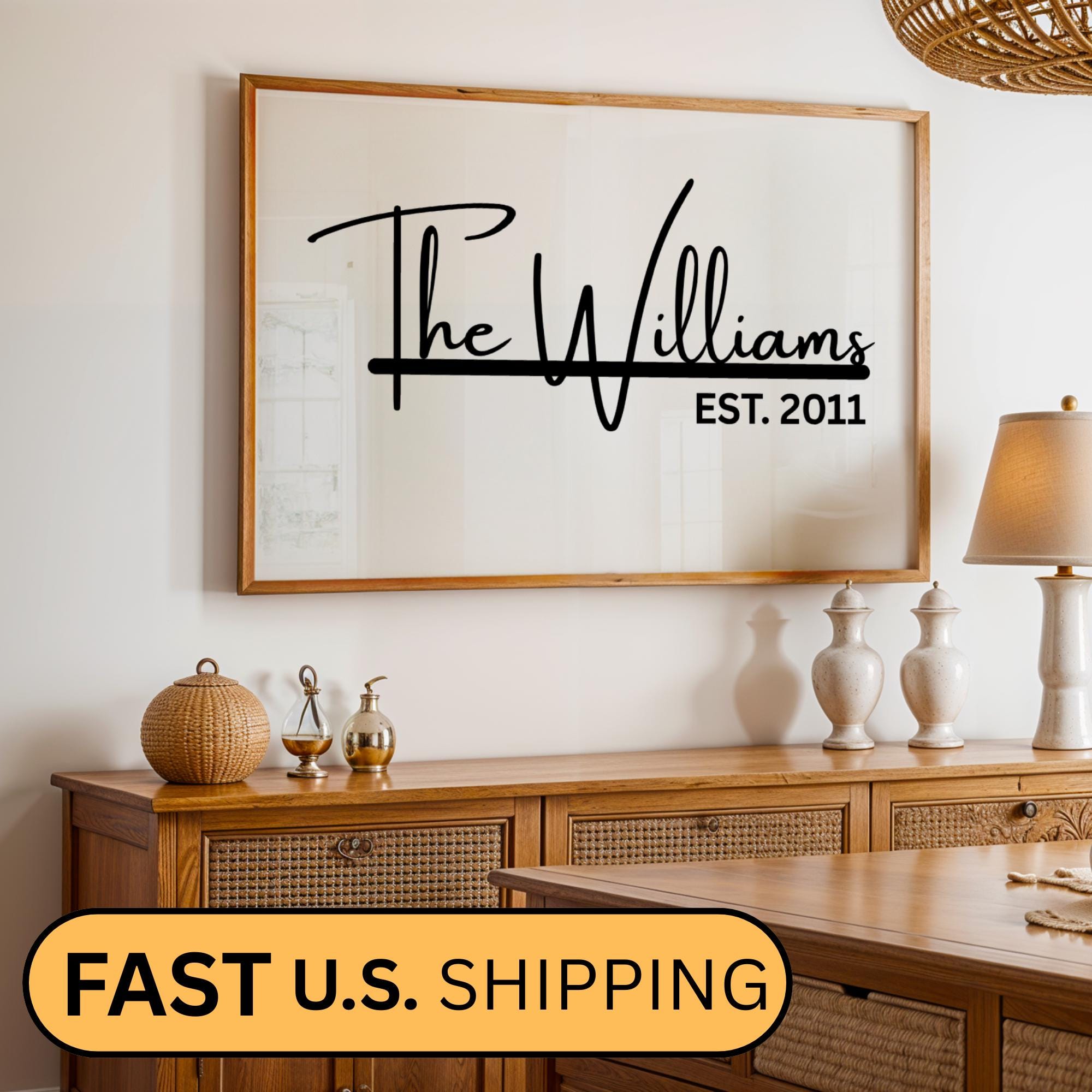 Custom framed canvas sign featuring a personalized family name and the anniversary date in a black and white minimalist style. Elegant wall art decor perfect for farmhouse, modern, or neutral-themed interiors. Ideal for home or office wall display in living rooms, entryways, or workspaces. Thoughtful housewarming, wedding, or anniversary gift idea with a timeless design.